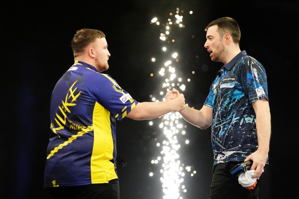 اثنين من اللاعبين السهام يصافحان بعد المباراة.