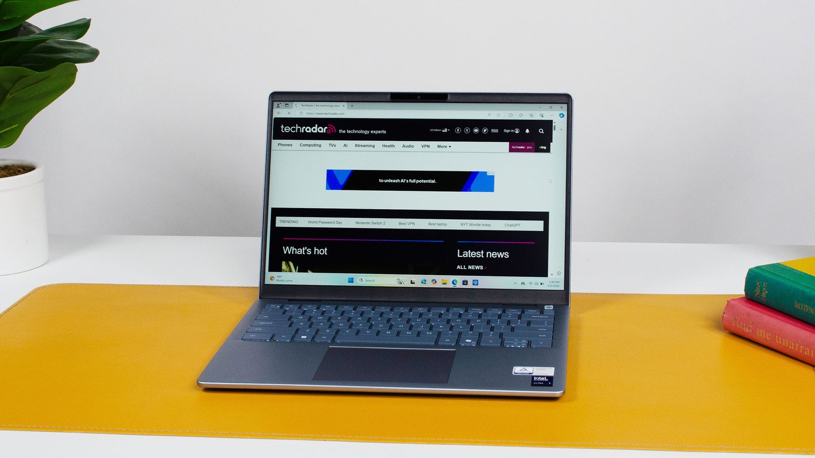 A Dell 14 Plus open to the TechRadar homepage