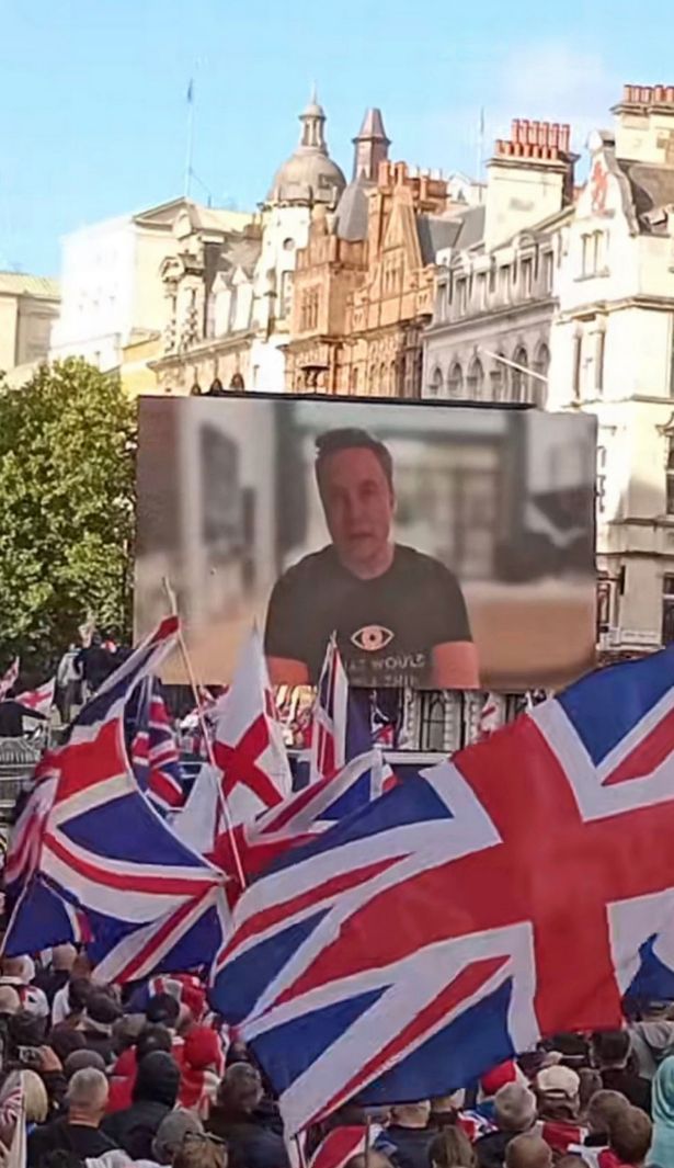 شاشة في احتجاج تومي روبنسون تظهر إيلون موسك يتحدث